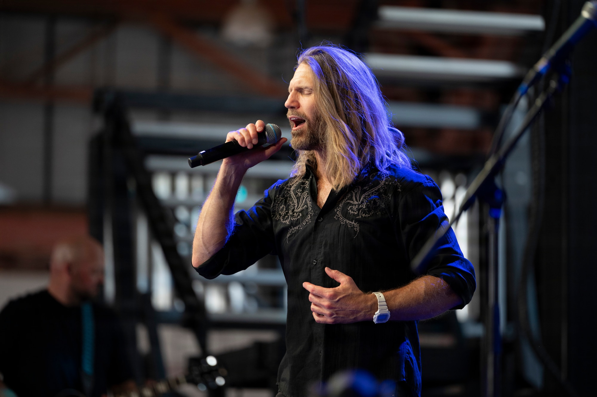 Jeff Vezain, Lt. Dan Band vocalist, sings during concert at Holloman Air Force Base, New Mexico, July 12, 2026. The band regularly visits military installations around the world to support service members and their families through music and outreach. (U.S. Air Force photo by Senior Airman Michelle Ferrari)