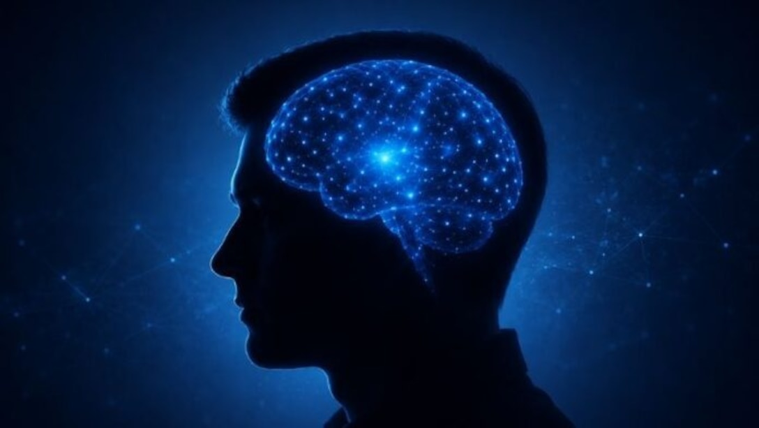 An AI image of a human head silhouette with an illuminated brain in the center. Neural pathways glow blue to illustrate brain activity.