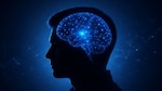 An AI image of a human head silhouette with an illuminated brain in the center. Neural pathways glow blue to illustrate brain activity.
