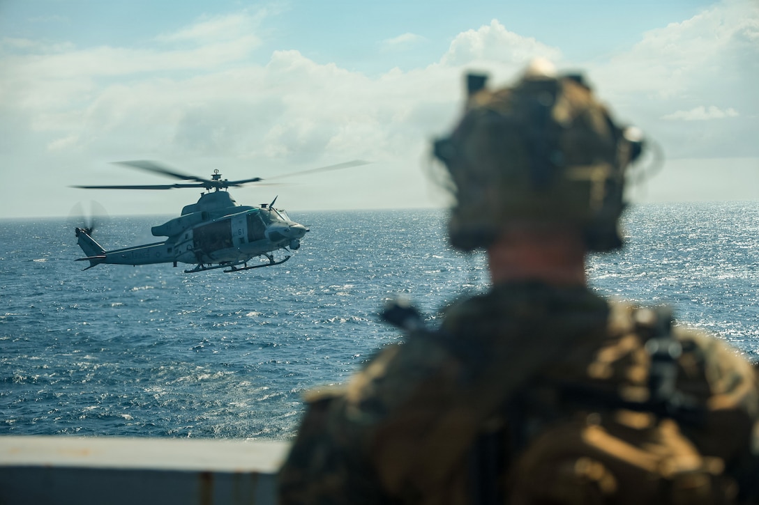 A U.S. Marine Corps UH-1Y Venom helicopter, assigned to Marine Medium Tiltrotor Squadron (VMM) 365 (Reinforced), Littoral Combat Force-24, prepares to hover over San Antonio-class amphibious transport dock USS San Antonio (LPD 17) during a Maritime Interdiction Operation Full Mission Profile off the coast of Venezuela, July 17, 2026. U.S. military forces are deployed to the U.S. Southern Command area of responsibility in support of Operation SOUTHERN SPEAR, Department of War-directed operations, and the president’s priorities to disrupt illicit drug trafficking, deter malign actors and protect the homeland through continuous presence. (U.S. Marine Corps photo)