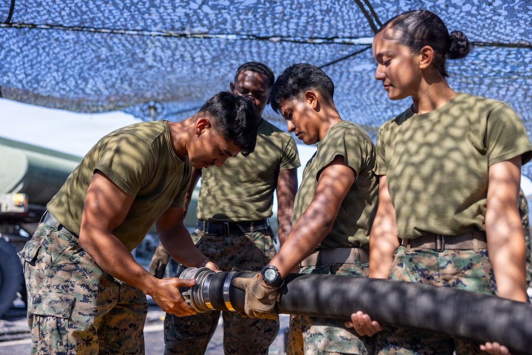 U.S. Marines with 2nd Marine Aircraft Wing prepare to empty a fuel hose during a Semitrailer Refueler Operator Course at Marine Corps Auxiliary Landing Field Bogue, North Carolina, July 10, 2026. The SROC trains qualified Marines in the motor vehicle operator occupation to operate and maintain MK-31 tactical tractors and MK970 semitrailer refuelers to support the fueling of aviation and ground equipment. (U.S. Marine Corps photo by Lance Cpl. Dillon Anderson)