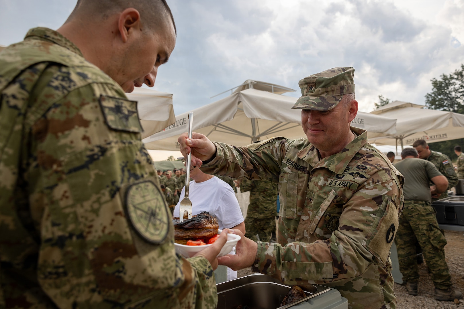 Minnesota National Guard Brig. Gen. Joseph Sharkey, the 34th Infantry Division commander, serves steaks to multinational partners during Exercise Combat Power 26, June 23-July 1, 2026, in Croatia.