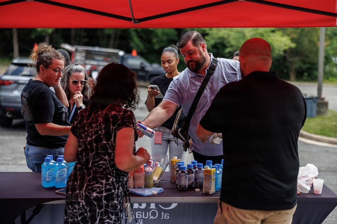 Community members try free drink samples during the grand opening of “Bites on Site” on Marine Corps Base Quantico, Virginia, July 9, 2026. The grand opening featured local food vendors, activities, and a raffle with the food trucks operating at 3380 Russell Road Wednesdays through Fridays from 1100 to 1400. (U.S. Marine Corps photo by Sgt. Dean Gurule)