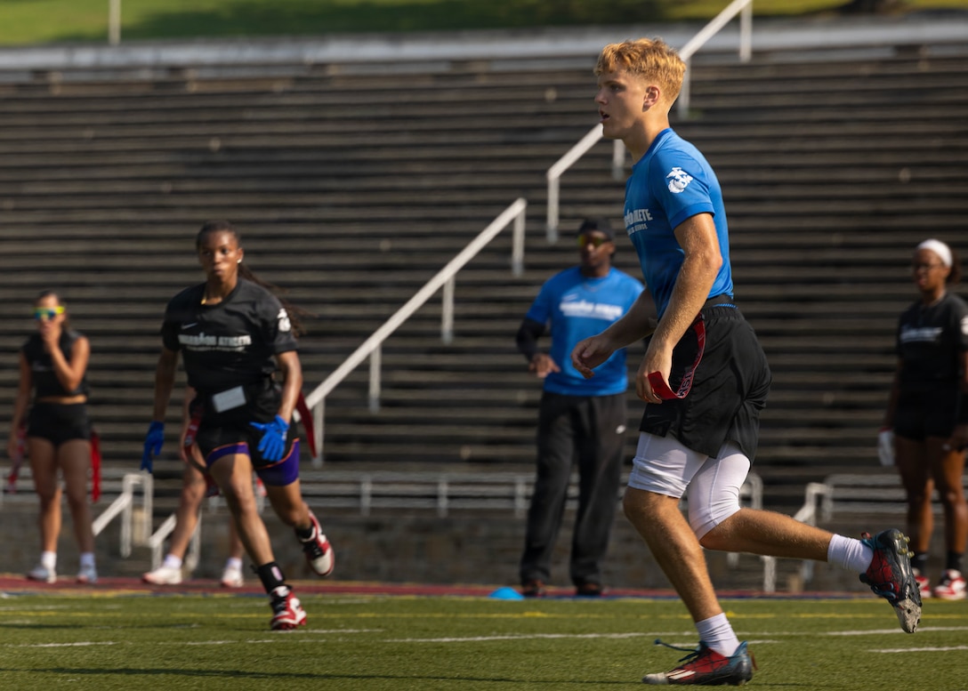 U.S. Marines Corps Lance Cpl. Austin Hart, right, a player with the All-Marine Sports Flag Football men’s team, practices drills at Butler Stadium on Marine Corps Base Quantico, Virginia, July 15, 2026. The All-Marine Sports Flag Football men’s and women’s teams practiced drills before their upcoming tournament in San Antonio. The program provides elite Marine athletes opportunities to compete at the Armed Forces Championships, National Championships, Conseil International du Sport Militaire Championships, and the Olympic Games. (U.S. Marine Corps photo by Cpl. Harleigh Faulk)