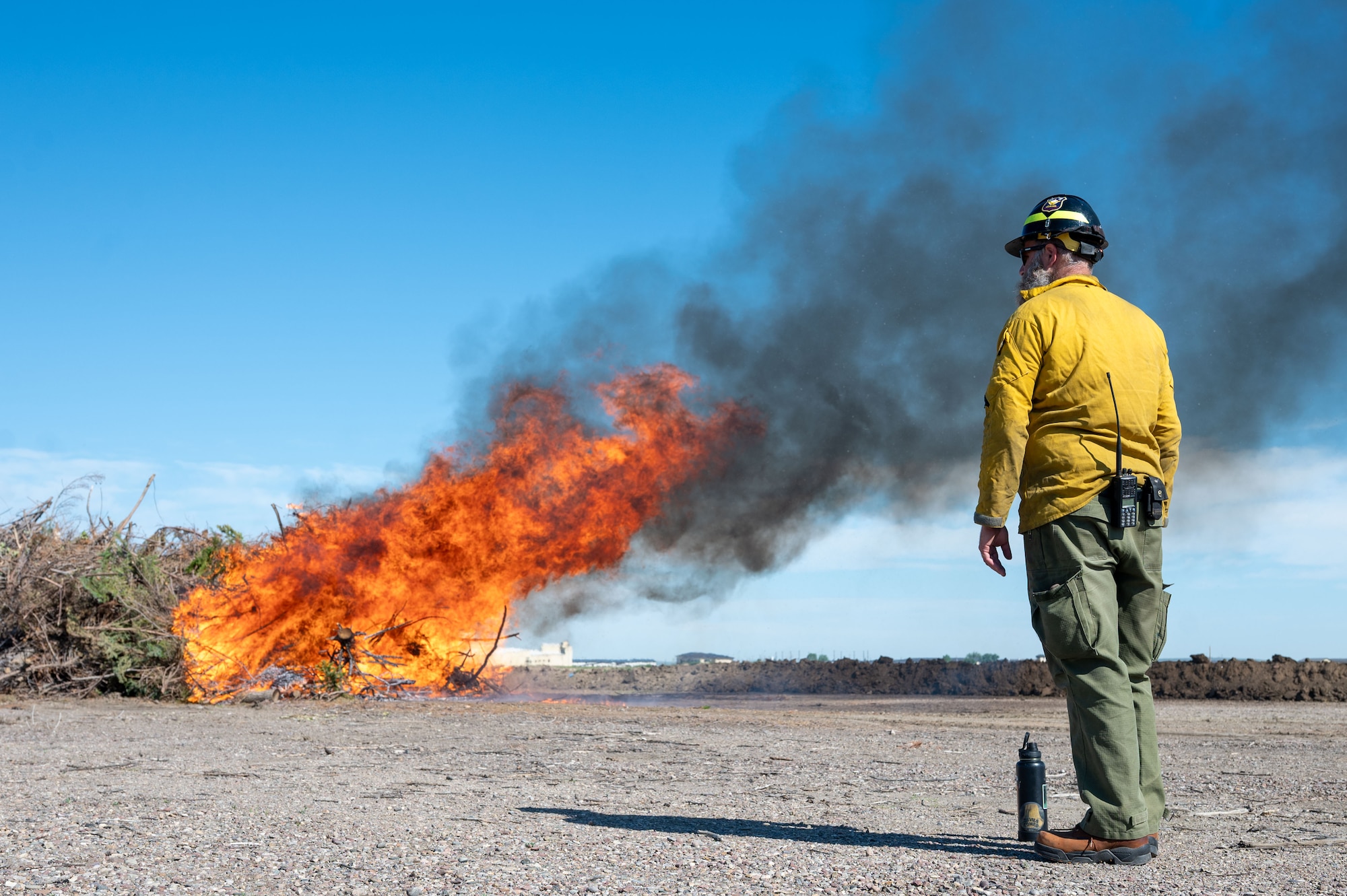 Chris Rogers, 28th Civil Engineering Squadron wildland firefighter, monitors a prescribed burn at Malmstrom Air Force, Montana, July 8, 2026.
