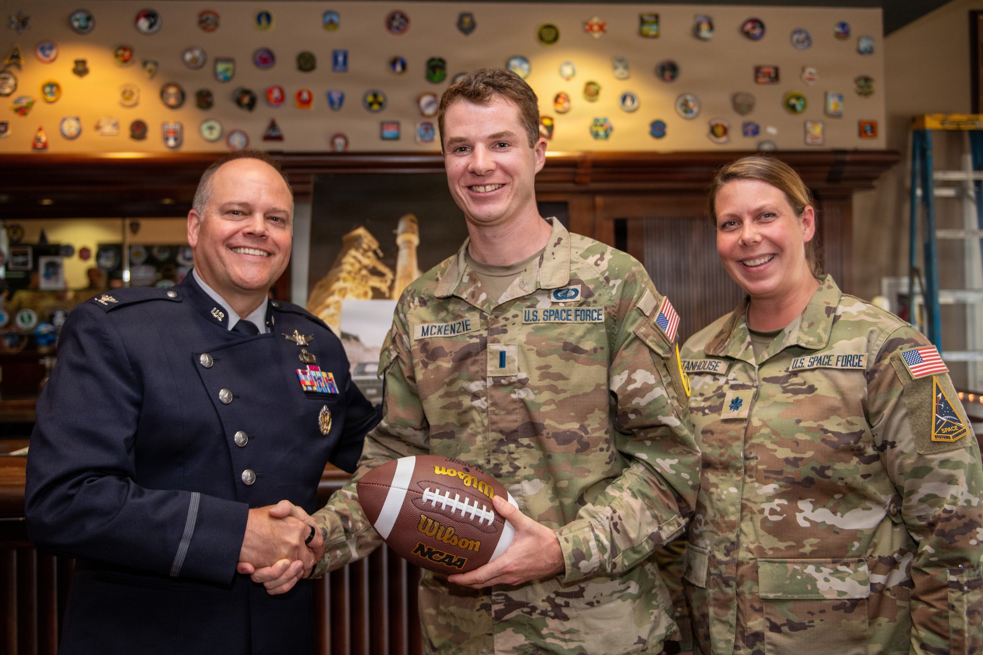 Three officer's pose with a ceremonial football.