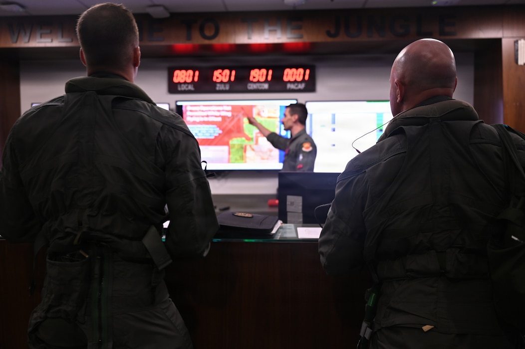 U.S. Air Force Brig. Gen. David Berkland, 56th Fighter Wing commander, right, and a student pilot assigned to the 63rd Fighter Squadron attend a pre-flight brief for a training mission at Luke Air Force Base, Arizona, July 15, 2026.