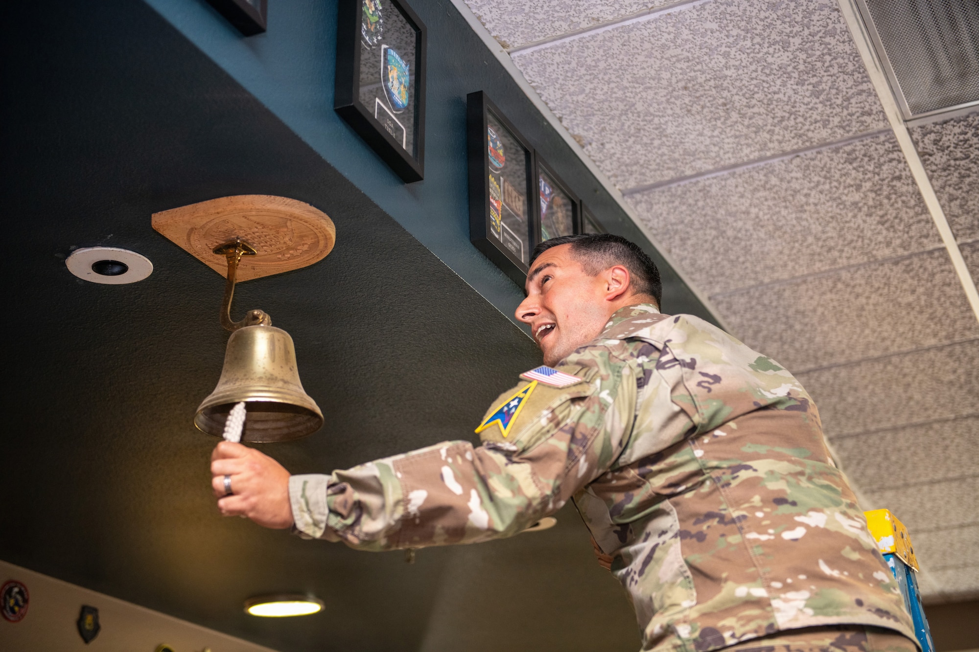 Officer rings a ceremonial bell.