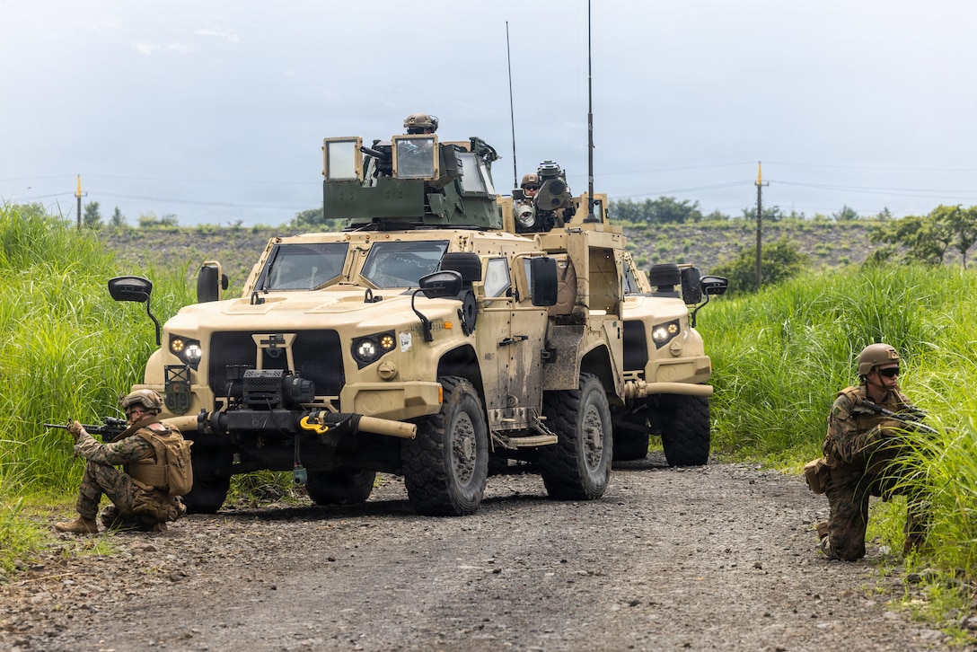U.S. Marines with 2nd Battalion, 8th Marine Regiment, forward deployed with 4th Marine Regiment, 3rd Marine Division, as part of the Unit Deployment Program, post security in front of a Joint Light Tactical Vehicle while participating in a M41A7 Saber weapon system and Mk 19 Mod 3 40 mm automatic grenade launcher live-fire training during Fuji Viper 26.3 at the Combined Arms Training Center, Camp Fuji, Japan, July 9, 2026. Fuji Viper is an annual exercise that enables Marines operating in Japan to conduct combined arms live-fire training, enhancing operational readiness, tactical proficiency and lethality throughout the first island chain. (U.S. Marine Corps photo by Lance Cpl. Oscar Ocampo)