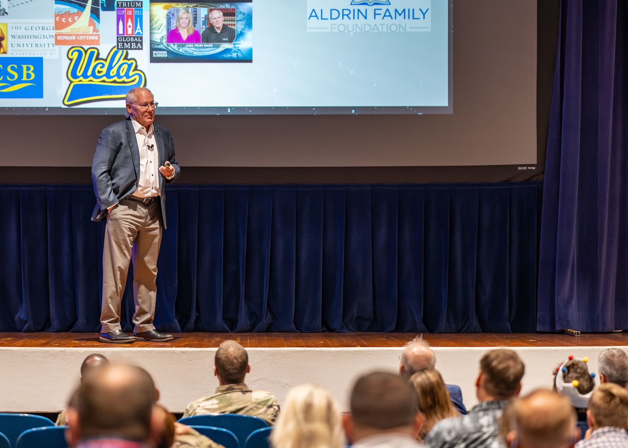 Dr. Andrew Aldrin speaks with attendees for a presentation.