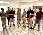 Munson Army Health Center leaders joined the Fort Leavenworth Armed Forces Wellness Center Team for a ribbon cutting ceremony marking the reopening of the AFWC in its new location within Munson, June 29, from left Sgt. Maj. Jason Trevino, Drake Grinde, Brooks Roth, Lt. Col. Baron Moehlenbrock, Capt. Lorrie Santoy, Brett Stoddard, Marie Dubois, and Theodore Paul. The relocation brings the Armed Forces Wellness Center into the heart of the health center, strengthening collaboration between healthcare providers and wellness professionals while making it even easier for beneficiaries to access resources that support lifelong health, fitness and military readiness.