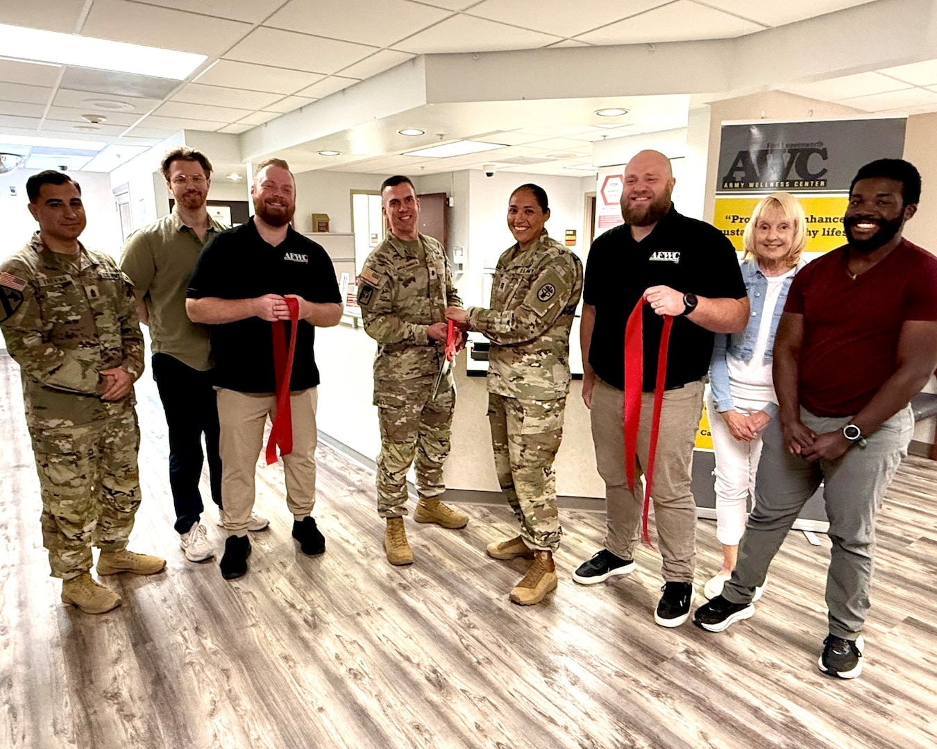 Munson Army Health Center leaders joined the Fort Leavenworth Armed Forces Wellness Center Team for a ribbon cutting ceremony marking the reopening of the AFWC in its new location within Munson, June 29, from left Sgt. Maj. Jason Trevino, Drake Grinde, Brooks Roth, Lt. Col. Baron Moehlenbrock, Capt. Lorrie Santoy, Brett Stoddard, Marie Dubois, and Theodore Paul. The relocation brings the Armed Forces Wellness Center into the heart of the health center, strengthening collaboration between healthcare providers and wellness professionals while making it even easier for beneficiaries to access resources that support lifelong health, fitness and military readiness.
