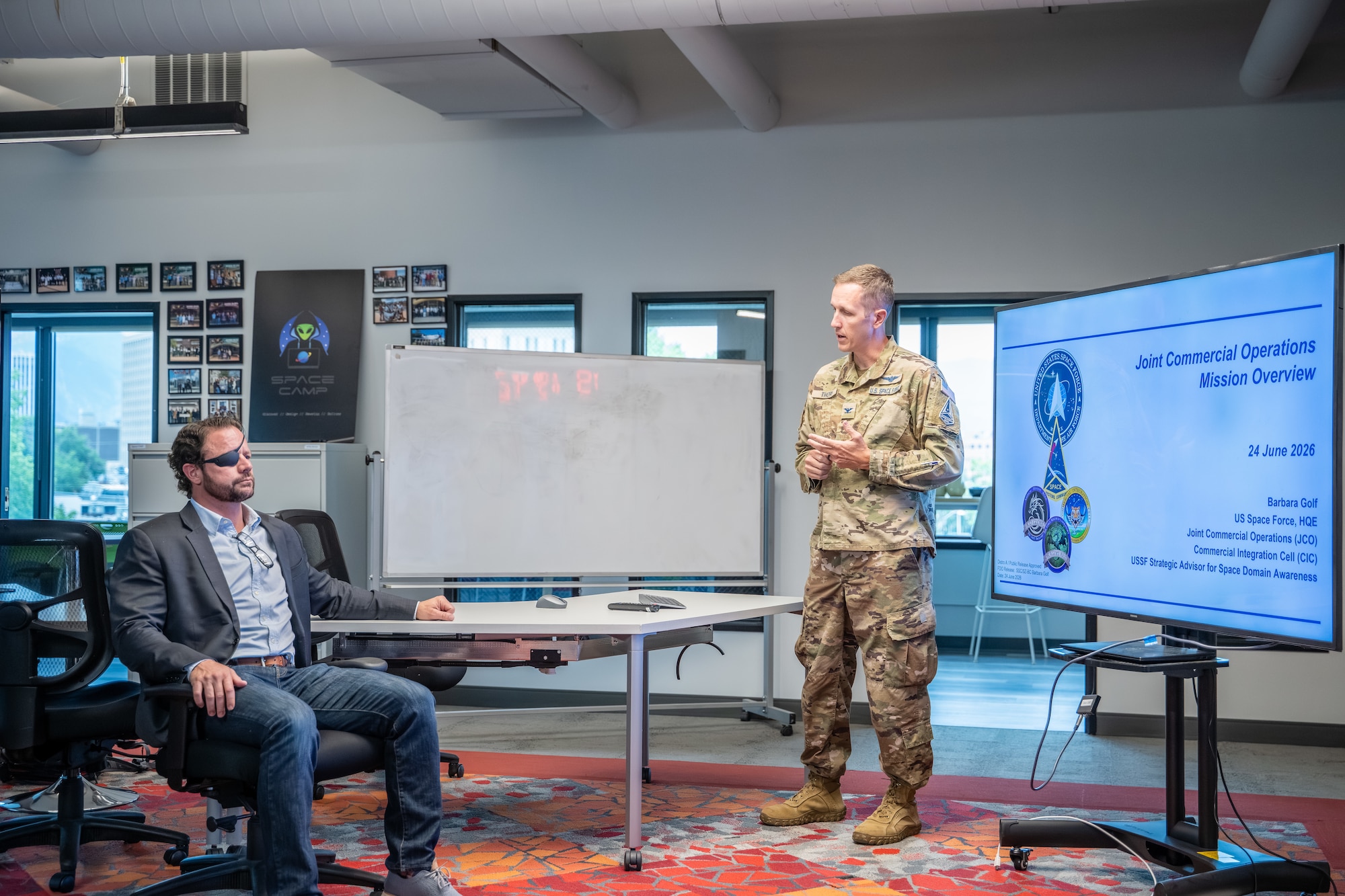 Col. Galen Thorp briefs Dan Crenshaw during a congressional delegation visit to the JCO.