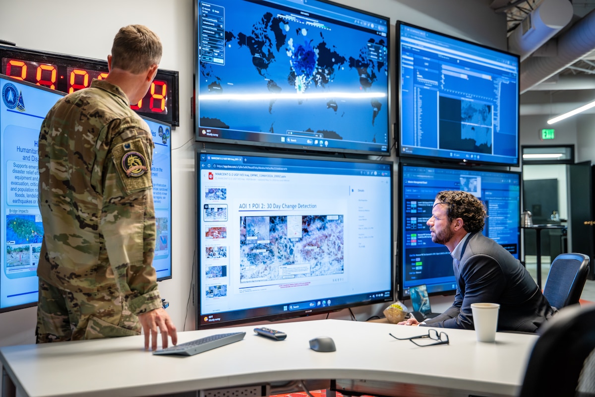 Dan Crenshaw observes an operational display at the Joint Commercial Operations