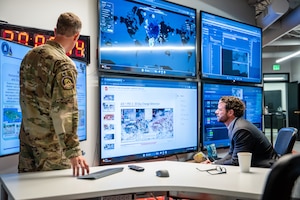 U.S. Rep. Dan Crenshaw (R-TX) observes an operational display as U.S. Space Force Col. Galen Thorp, Joint Commercial Operations deputy director, provides a briefing during a congressional delegation visit to the JCO in Colorado Springs, Colorado, July 9, 2026. The visit offered Crenshaw a firsthand look at how JCO integrates commercial data and capabilities to strengthen space domain awareness and support national security operations. (U.S. Space Force photo by Dalton Prejeant)