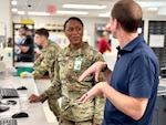 Munson Army Health Center Director Col. Jolanda L. J. Walker hears from federal employee Jason Brozek, a pharmacist and supervisor in the health center pharmacy, Saturday, Feb. 22. Federal employees work alongside service members in military treatment facilities and keep operations running in support of medical readiness and ready medical forces when service members deploy, train, or transfer.
