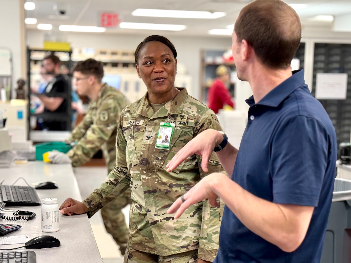 Munson Army Health Center Director Col. Jolanda L. J. Walker hears from federal employee Jason Brozek, a pharmacist and supervisor in the health center pharmacy, Saturday, Feb. 22. Federal employees work alongside service members in military treatment facilities and keep operations running in support of medical readiness and ready medical forces when service members deploy, train, or transfer.