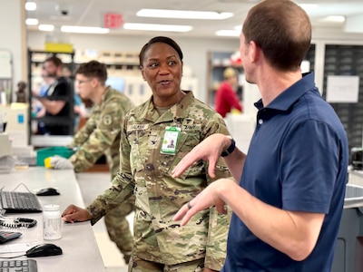 Munson Army Health Center Director Col. Jolanda L. J. Walker hears from federal employee Jason Brozek, a pharmacist and supervisor in the health center pharmacy, Saturday, Feb. 22. Federal employees work alongside service members in military treatment facilities and keep operations running in support of medical readiness and ready medical forces when service members deploy, train, or transfer.