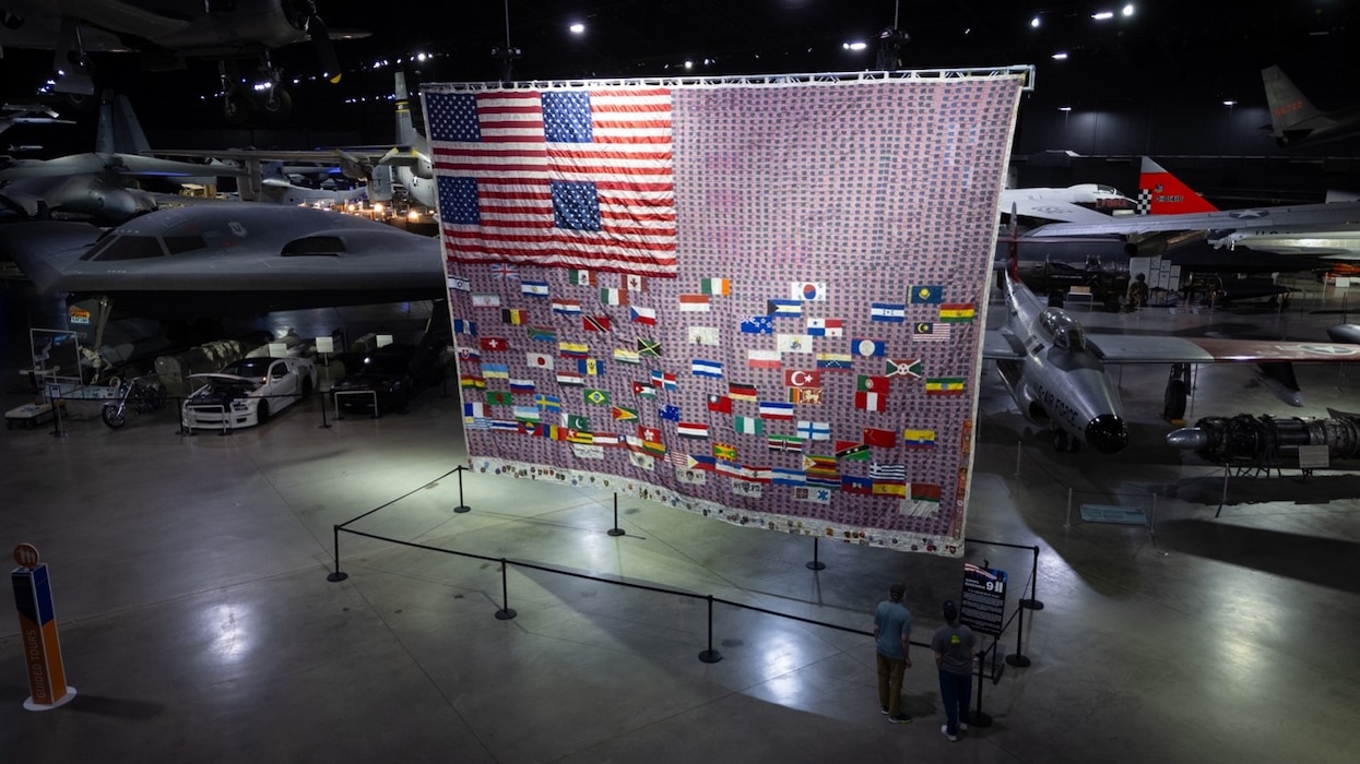 The 9/11 Memorial Flag shown in the Cold War Gallery at the National Museum of the U.S. Air Force. The 22-foot by 32-foot handmade memorial features 2,983 miniature American flags, 86 national flags and emblems representing rescue, recovery and emergency-response organizations.