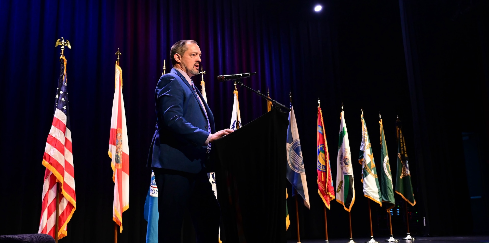 The master of ceremonies delivers remarks during the inaugural Florida Department of Homeland Security Awards Ceremony at the Clermont Performing Arts Center in Clermont, Florida, July 15, 2026. The event recognized state and federal partnerships as well as individuals nominated for their contribution during joint operations to protect our nation and safeguard the State of Florida in the past year.