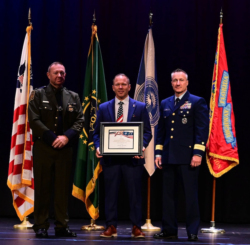 An award recipient poses with award presenters during the inaugural Florida Department of Homeland Security Awards Ceremony at the Clermont Performing Arts Center in Clermont, Florida, July 15, 2026. The event recognized state and federal partnerships as well as individuals nominated for their contribution during joint operations to protect our nation and safeguard the State of Florida in the past year.