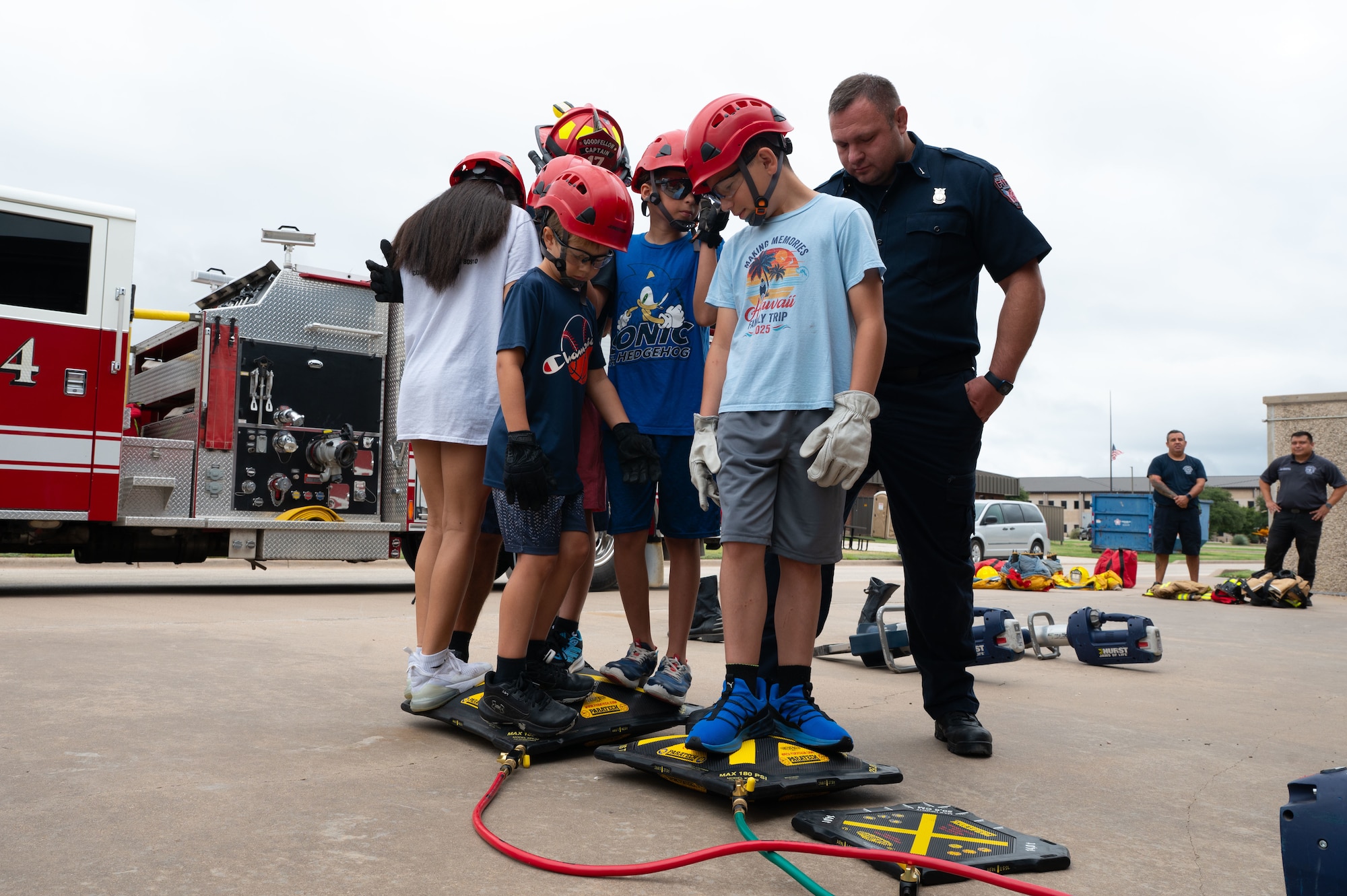Junior firefighters stand on rescue lifting airbags during a demonstration at the Junior Firefighter Camp, Goodfellow Air Force Base, Texas, July 14, 2026.
