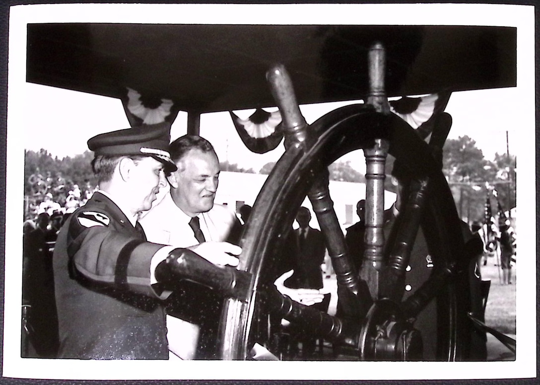 Dedication of the U.S. Army Transportation Museum. (Left to Right) U.S. Army Maj. Gen. Alton G. Post, Fort Eustis commander, and Honorable Mills P. Godwin, Governor, Commonwealth of Virginia, as they cut ribbon by spinning the wheel. (Courtesy photo by C.E. Williams, David Byrd, TASO Photo, from U.S. Army Transportation Museum Photo Collection)