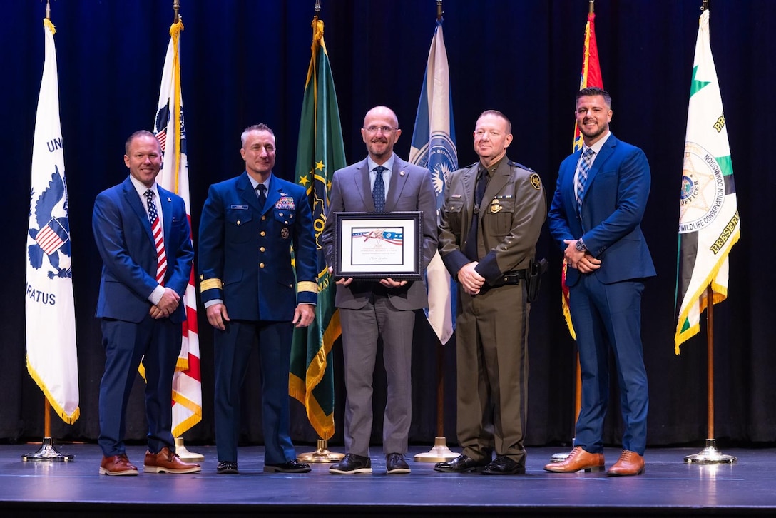 An award recipient poses with award presenters during the inaugural Florida Department of Homeland Security Awards Ceremony at the Clermont Performing Arts Center in Clermont, Florida, July 15, 2026. The event recognized state and federal partnerships as well as individuals nominated for their contribution during joint operations to protect our nation and safeguard the State of Florida in the past year.