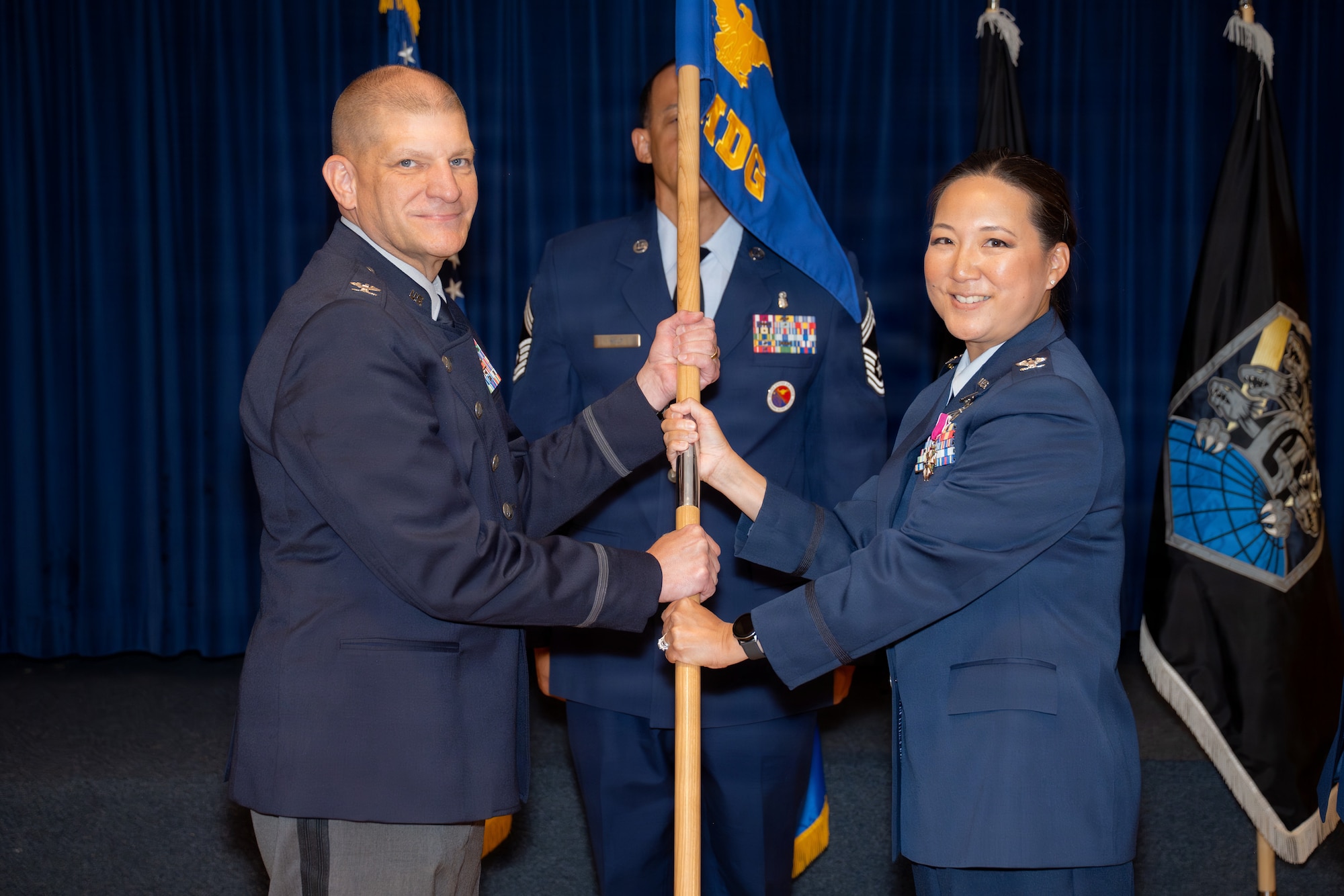 U.S. Air Force Col. Gloria Walski surrenders the guidon to U.S. Space Force Col. Kenneth Klock, Space Base Delta 1 commander,