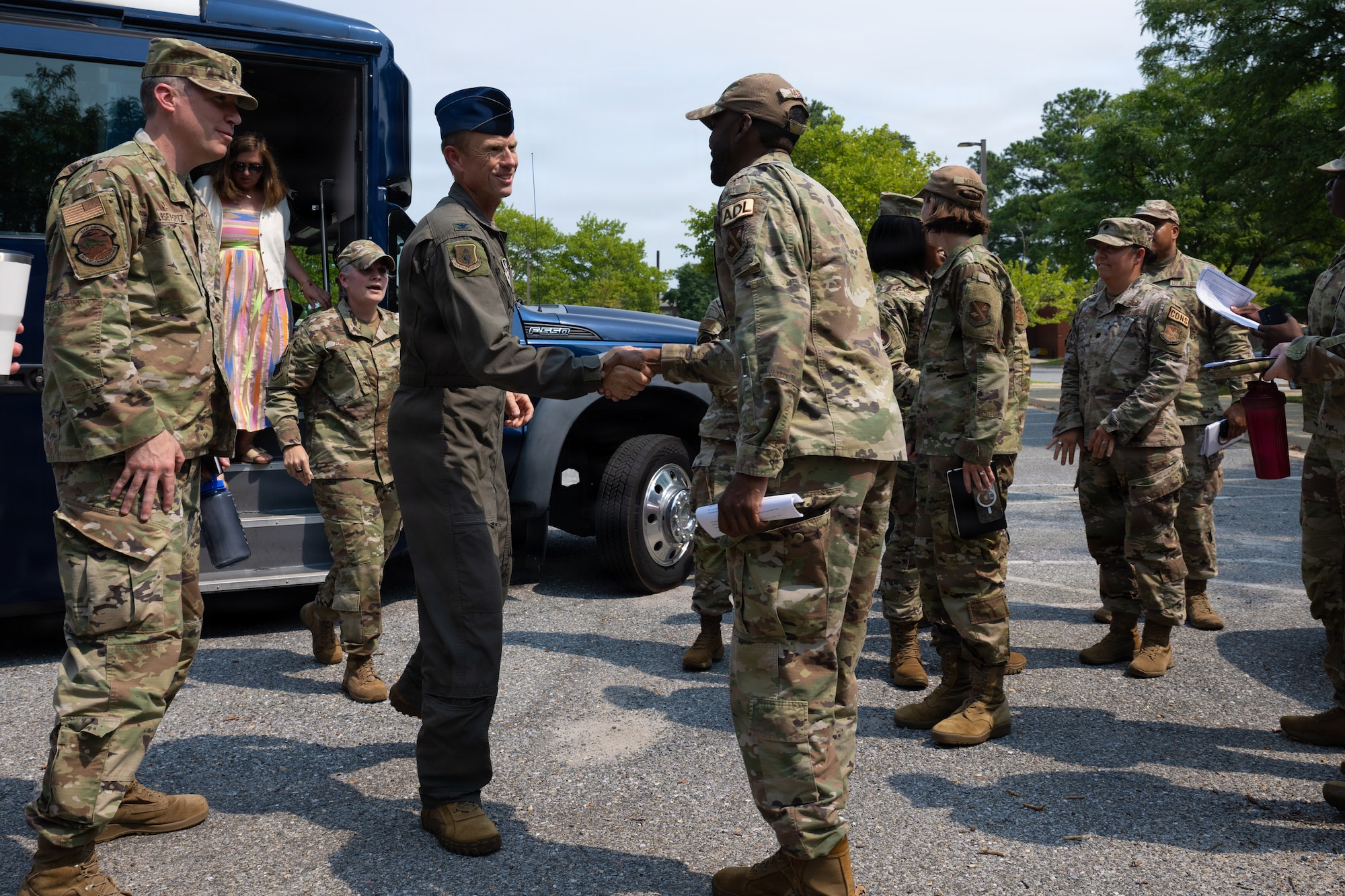 U.S. Air Force Col. Karl W. Seekamp, 316th Wing and installation commander, center, is greeted by Staff Sgt. Travion Harris, an airman dorm leader assigned to the 316th Civil Engineer Squadron.