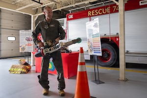 U.S. Air Force Col. Karl W. Seekamp, 316th Wing and installation commander, uses a hydraulic rescue tool while visiting the 316th Civil Engineer Squadron Fire and Emergency Services.