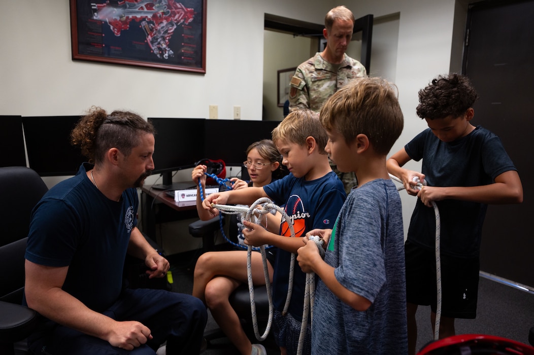 Goodfellow Fire Department Lt. Chris Hook, 17th Civil Engineer Squadron firefighter, demonstrates to junior firefighters how to tie a variety of knots during Junior Firefighter Camp, Goodfellow Air Force Base, Texas, July 15, 2026.
