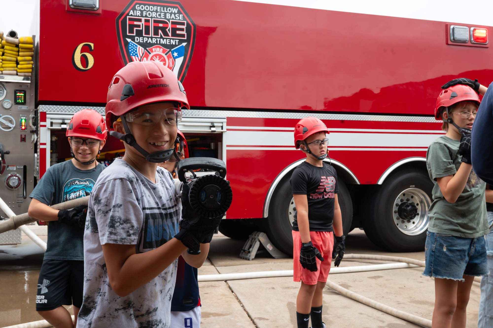 Joseph Ayala, junior firefighter, prepares for a fire hose exercise during Junior Firefighter Camp, Goodfellow Air Force Base, Texas, July 16, 2026.