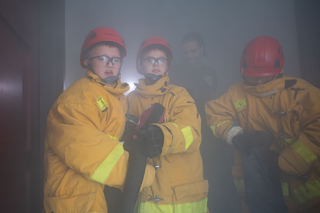 Dalton Silva and Lucas Crusberg participate in a search and rescue exercise during Junior Firefighter Camp, Goodfellow Air Force Base, Texas, July 16, 2026.