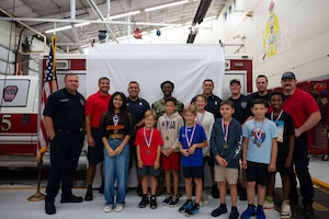 Goodfellow firefighters and junior firefighters pose for a picture on the last day of Junior Firefighter Camp, Goodfellow Air Force Base, Texas, July 17, 2026.
