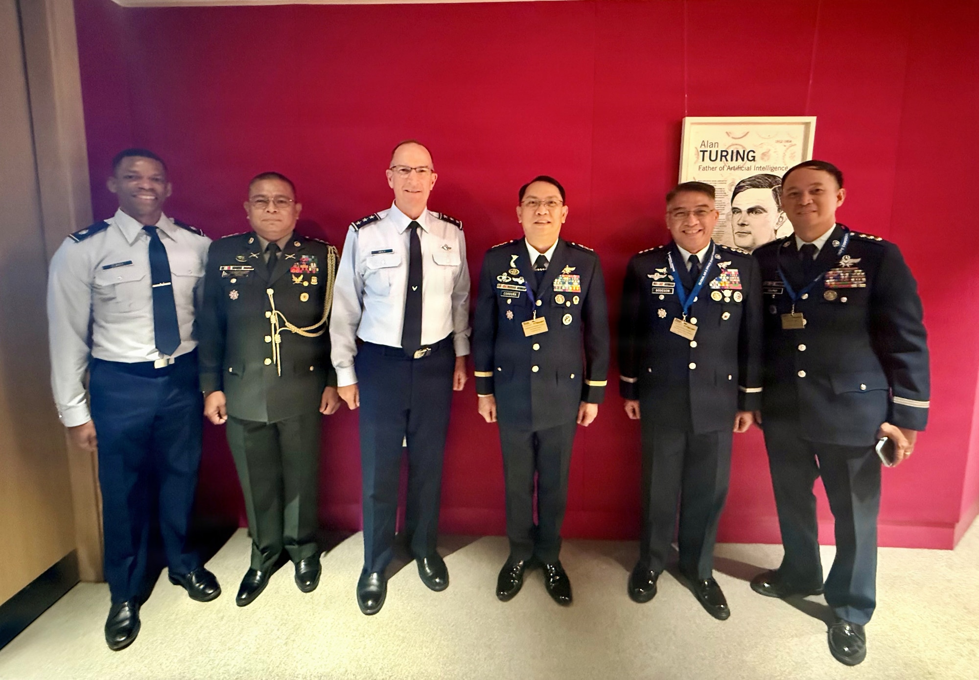 Military members stand and pose for a group photo