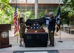 Kelly McKeague, Defense POW/MIA Accounting Agency director, and Jennifer Sabas, Director of the Daniel K. Inouye Institute, unveil the flag during a flag presentation ceremony at Joint Base Pearl Harbor-Hickam, Hawaii, July 17, 2026.