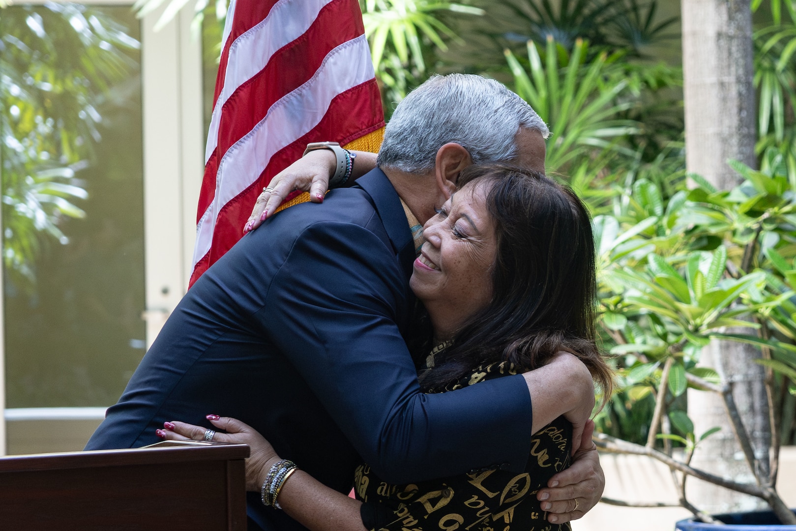 Kelly McKeague, Defense POW/MIA Accounting Agency director, and Jennifer Sabas, Director of the Daniel K. Inouye Institute, hug after the flag presentation ceremony at Joint Base Pearl Harbor-Hickam, Hawaii, July 17, 2026.