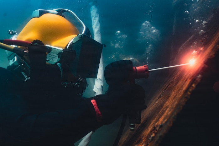 A New Zealand clearance diver welds into a mock ship hull during a salvage training dive during Exercise Rim of the Pacific 2026 in the Pacific Ocean off the coast of Oahu, Hawaii, July 14, 2026.