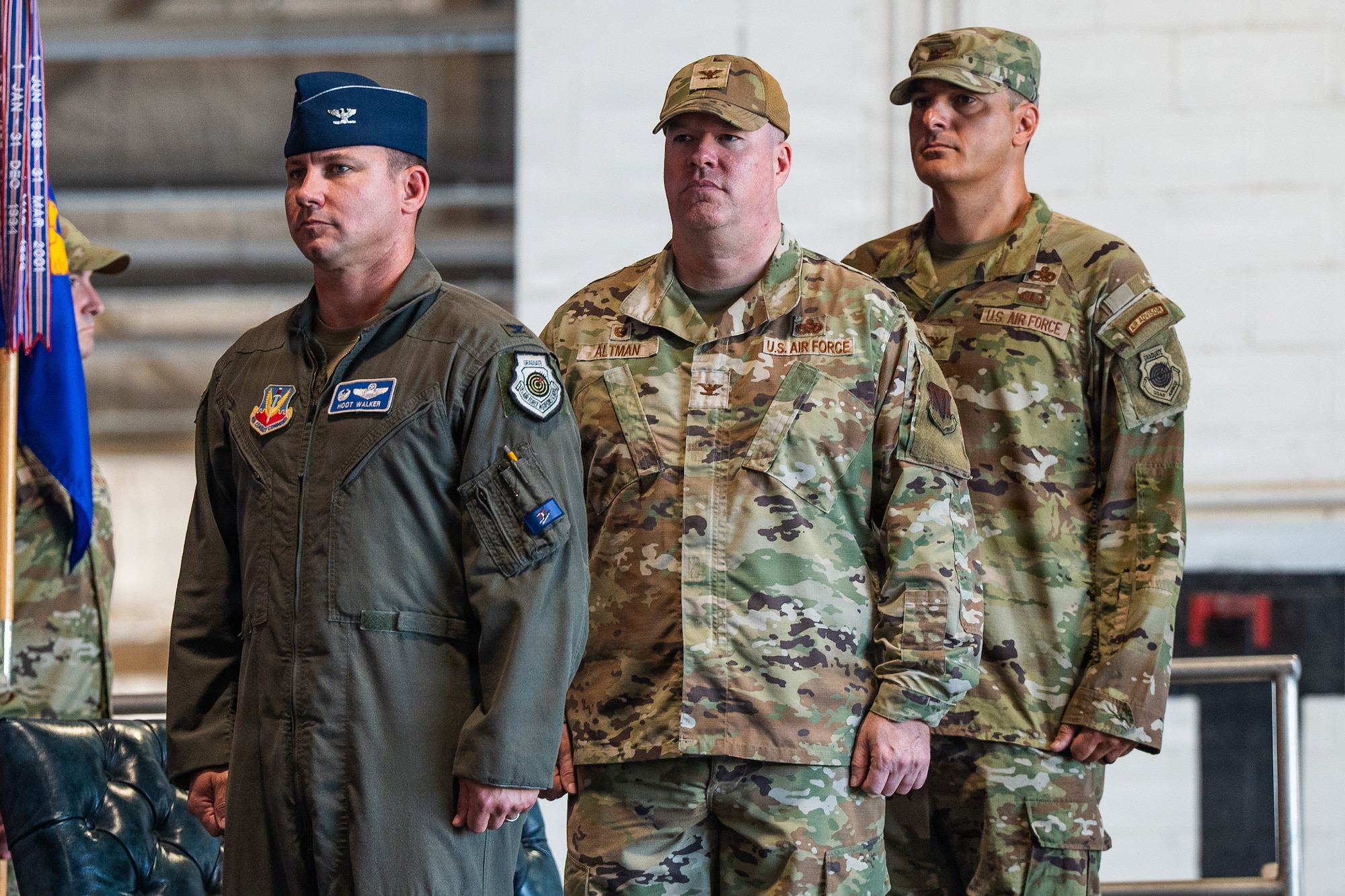 Three Airmen stand at attention