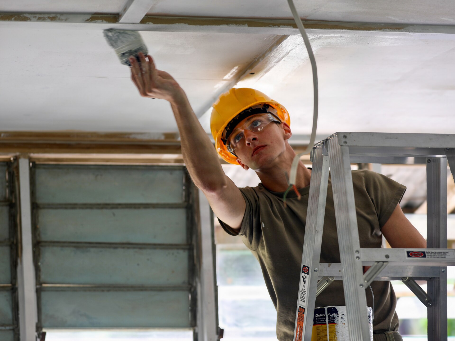 A U.S. Army Reserve Soldier assigned to the 844th Engineer Battalion paints the ceiling of a classroom at Igam Barracks during Exercise Tamiok Strike 26 in Lae, Papua New Guinea, July 15, 2026.