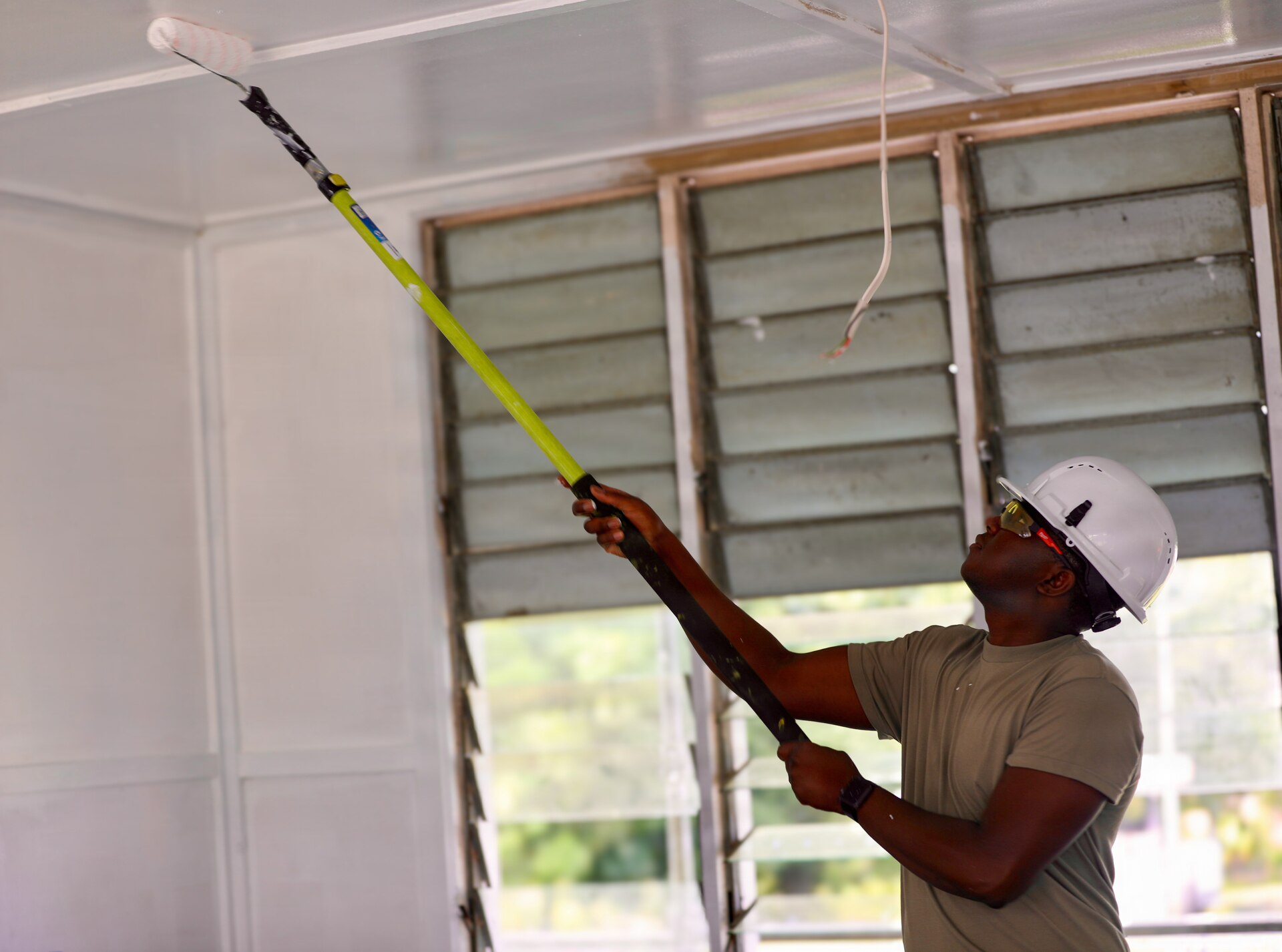 A U.S. Army Reserve Soldier assigned to the 844th Engineer Battalion paints the ceiling of a classroom at Igam Barracks during Exercise Tamiok Strike 26 in Lae, Papua New Guinea, July 15, 2026.