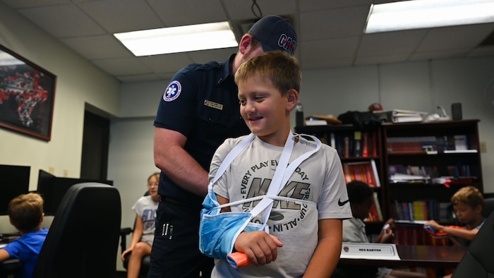 Dalton Silva, junior firefighter, participates in a first aid demonstration during the Junior Firefighter Camp, Goodfellow Air Force Base, Texas, July 13, 2026.