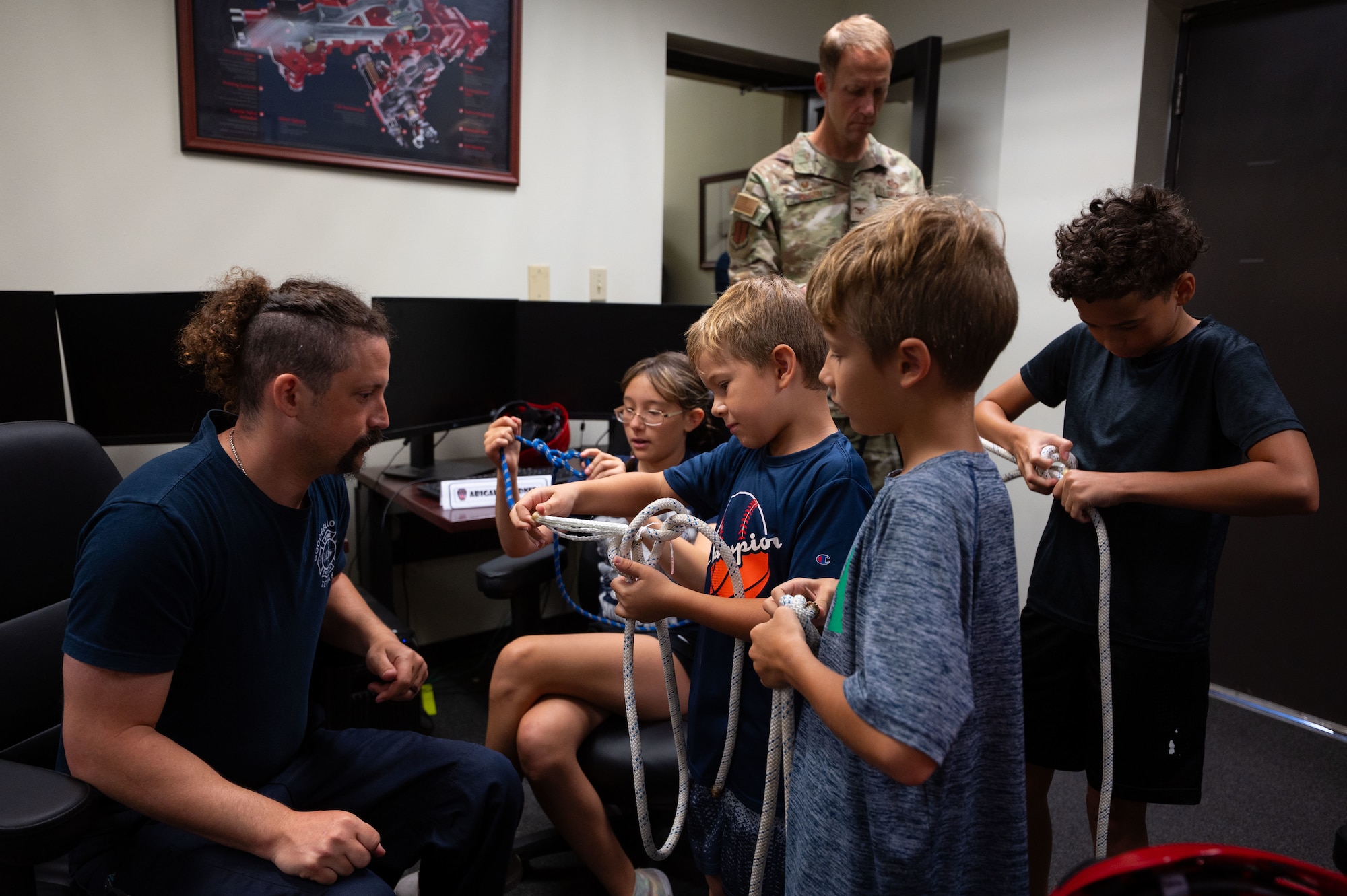 Goodfellow Fire Department Lt. Chris Hook, 17th Civil Engineer Squadron firefighter, demonstrates to junior firefighters how to tie a variety of knots during Junior Firefighter Camp, Goodfellow Air Force Base, Texas, July 15, 2026.