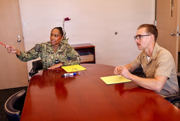 Lt. Tristan McLean Loesberg (right), a staff anesthesiologist assigned to Navy Medicine Readiness and Training Command Twentynine Palms, meets with Capt. Janiese Cleckley (left), the commanding officer, during the command's "Commanding Officer for a Day" program at Naval Hospital Twentynine Palms, California, June 16, 2026. The program provides junior officers the opportunity to shadow command leadership and gain insight into the responsibilities of leading a military treatment facility. (U.S. Navy photo by Christopher Jones, NH/NMRTC Twentynine Palms public affairs officer).