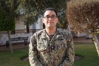 Hospital Corpsman 3rd Class Nicolas Pantoja, assigned to Navy Medicine Readiness and Training Command Rota, serves as the Overseas Screening and Exceptional Family Member Program coordinator at Naval Station Rota, Spain, May 10, 2025. In his role, Pantoja helps ensure service members and their families are prepared for overseas assignments, supporting fleet readiness throughout the European and African areas of responsibility. (U.S. Navy photo by Lt. Cmdr. Alicia Sacks)