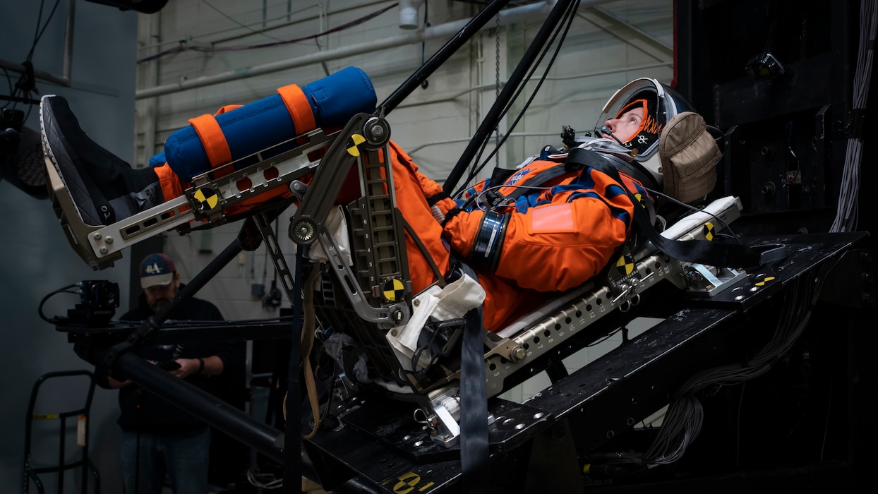 A U.S. Air Force volunteer tests the next replica of a space suit and seat for the Orion spacecraft in the vertical deceleration tower at Wright-Patterson Air Force Base, Ohio, Nov. 3, 2023. The Air Force Research Laboratory’s 711th Human Performance Wing sought active-duty military volunteers for an August 2026 collaborative study with NASA to evaluate the impact forces astronauts will face during future lunar landings. (U.S. Air Force photo / Richard Eldridge)