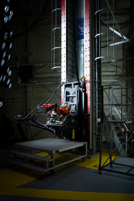 A U.S. Air Force volunteer tests the next replica of a space suit and seat for the Orion spacecraft in the vertical deceleration tower at Wright-Patterson Air Force Base, Ohio, Nov. 3, 2023. The Air Force Research Laboratory’s 711th Human Performance Wing sought active-duty military volunteers for an August 2026 collaborative study with NASA to evaluate the impact forces astronauts will face during future lunar landings. (U.S. Air Force photo / Richard Eldridge)