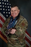 U.S. Air Force Lt. Col. Ron Cloutier, Rhode Island National Guard Endurance Team coordinator, presents an arrangement of medals he has earned from running marathons with the Rhode Island National Guard's Marathon and Endurance teams at Quonset Air National Guard Base, North Kingstown, RI, April 11, 2025.