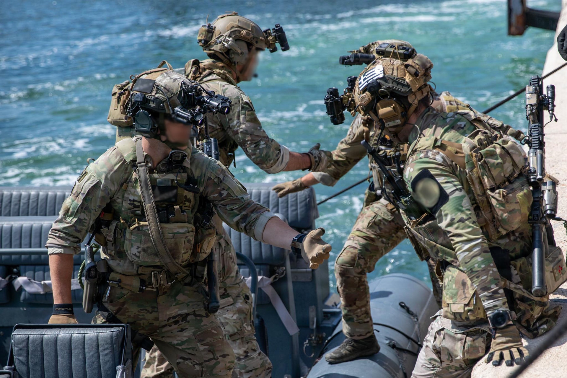 Green Berets with U.S. Army 20th Special Forces Group (Airborne) and Greek special operations forces soldiers load into a rigid hull inflatable boat during Trojan Footprint 2026 at Skaramangas Naval Base, Greece, May 14, 2026. Trojan Footprint 2026 enables participating NATO Allies and partner SOF to integrate their unique capabilities into seamless multi-domain and joint-combined operations. (U.S. Army National Guard photo by 1st Sgt. HollyAnn Nicom)